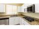 Modern kitchen with granite countertops and stainless steel appliances, ready for cooking at 3828 Prairie Orchid Ave, North Las Vegas, NV 89081
