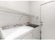 Convenient laundry room with shelving and a full-size washer and dryer at 3828 Prairie Orchid Ave, North Las Vegas, NV 89081