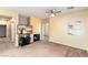 Cozy living room with a fireplace, TV and lots of natural light from a large window at 3828 Prairie Orchid Ave, North Las Vegas, NV 89081