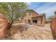 Large backyard featuring perimeter brick wall with mature shade tree at 4421 Galapagos Ave, North Las Vegas, NV 89084