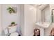 Powder bathroom with pedestal sink, toilet, and decorative accents at 4421 Galapagos Ave, North Las Vegas, NV 89084