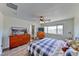 Bedroom with wood floors, bright window, ceiling fan and a chest of drawers at 4421 Galapagos Ave, North Las Vegas, NV 89084