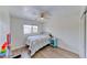 Cozy bedroom features a ceiling fan, wood-look floors, and a window offering natural light at 4421 Galapagos Ave, North Las Vegas, NV 89084