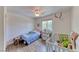 Comfortable bedroom with window, wood-look floors, and neutral decor at 4421 Galapagos Ave, North Las Vegas, NV 89084