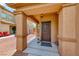 Charming front porch with decorative wreath and lantern, creating a welcoming entrance at 4421 Galapagos Ave, North Las Vegas, NV 89084