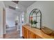 Upstairs hallway area with wood floors and stylish mirror with decorative touches at 4421 Galapagos Ave, North Las Vegas, NV 89084