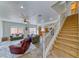 Bright living room showcasing cozy seating and staircase access to the second floor at 4421 Galapagos Ave, North Las Vegas, NV 89084
