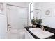 Clean bathroom featuring a shower over tub, granite counter, and white paneled walls at 50 Grey Feather Dr, Las Vegas, NV 89135