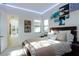 Cozy bedroom featuring soft lighting, comfortable bed, and wall decorations at 50 Grey Feather Dr, Las Vegas, NV 89135