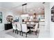 Refined dining room featuring modern chandelier and an adjacent view of the kitchen at 50 Grey Feather Dr, Las Vegas, NV 89135