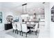 Bright dining room featuring modern lighting fixtures, a dark wood table, and a stylish area rug at 50 Grey Feather Dr, Las Vegas, NV 89135