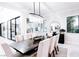 Bright dining room features a modern chandelier, large windows and stylish decor at 50 Grey Feather Dr, Las Vegas, NV 89135