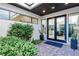 Inviting entryway featuring lush landscaping and a double door leading into the home at 50 Grey Feather Dr, Las Vegas, NV 89135