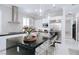 Modern kitchen boasts stainless steel appliances, granite countertops, and ample cabinet space at 50 Grey Feather Dr, Las Vegas, NV 89135