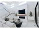 Elegant living room boasts an open floor plan with modern fireplace and staircase at 50 Grey Feather Dr, Las Vegas, NV 89135