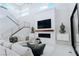 Bright living room featuring a modern fireplace, sleek staircase, and comfortable sectional seating at 50 Grey Feather Dr, Las Vegas, NV 89135