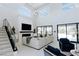 Bright, open-concept living room with high ceilings, a fireplace, and large glass doors to the backyard at 50 Grey Feather Dr, Las Vegas, NV 89135
