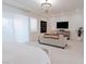 Bright and airy main bedroom with a chandelier, large windows, and comfortable seating area at 50 Grey Feather Dr, Las Vegas, NV 89135