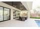 Elegant covered patio with ceiling fans, outdoor furniture, and access to a refreshing pool, creating an ideal space for relaxation at 50 Grey Feather Dr, Las Vegas, NV 89135