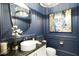 Elegant powder room showcases stylish blue walls, modern fixtures, and decorative lighting at 50 Grey Feather Dr, Las Vegas, NV 89135
