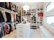 An elegant walk-in closet with shelving and storage for clothes and accessories at 50 Grey Feather Dr, Las Vegas, NV 89135