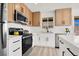 Bright kitchen with stainless steel appliances, white countertops, and modern cabinetry at 5030 E Hacienda Ave, Las Vegas, NV 89122