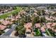 Scenic aerial view of lush suburban neighborhood featuring a golf course and beautiful homes at 5228 Painted Lakes Way, Las Vegas, NV 89149