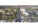 An aerial view displays a community with mature trees, golf course, and shopping centers nearby at 5228 Painted Lakes Way, Las Vegas, NV 89149