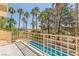 Balcony view shows backyard pool and lush palm trees, creating a private tropical oasis at 5228 Painted Lakes Way, Las Vegas, NV 89149