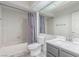 Bathroom with tub/shower combo, grey vanity, and large mirror at 5228 Painted Lakes Way, Las Vegas, NV 89149