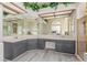 Bathroom featuring double sinks, wood floors, grey cabinets, and a gold-trimmed shower at 5228 Painted Lakes Way, Las Vegas, NV 89149