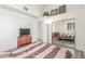 View of furnished bedroom with mirrored closet doors and a ceiling fan at 5228 Painted Lakes Way, Las Vegas, NV 89149