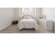 Bright bedroom with wood floors, window bench and white furniture at 5228 Painted Lakes Way, Las Vegas, NV 89149