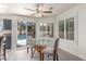 Bright dining area featuring a glass table and access to the outdoor pool at 5228 Painted Lakes Way, Las Vegas, NV 89149