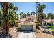 Charming single-story home with a two-car garage and lush tropical landscaping at 5228 Painted Lakes Way, Las Vegas, NV 89149