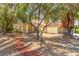 Home surrounded by lush trees and landscape design at 5228 Painted Lakes Way, Las Vegas, NV 89149