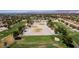 Aerial shot featuring a golf course with greens, sand traps, and distant mountain views at 5228 Painted Lakes Way, Las Vegas, NV 89149