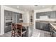 Stylish kitchen featuring an island with granite countertops, stainless steel appliances, and gray cabinets at 5228 Painted Lakes Way, Las Vegas, NV 89149