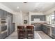 Modern kitchen with granite counters, stainless appliances and a central island with seating at 5228 Painted Lakes Way, Las Vegas, NV 89149