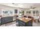 Well-lit kitchen with a granite countertop island, stainless steel appliances, and ample cabinet space at 5228 Painted Lakes Way, Las Vegas, NV 89149