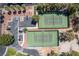 Aerial view highlighting tennis courts with lush landscaping and parking at 5228 Painted Lakes Way, Las Vegas, NV 89149