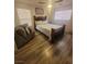Comfortable bedroom with a queen-sized bed, cozy chair, and natural light at 5404 Walcott Dr, Las Vegas, NV 89118