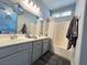 Well-lit bathroom with double sinks, bathtub, and modern fixtures at 6292 Yucca Valley Ct, Las Vegas, NV 89142