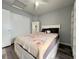 Cozy bedroom featuring a bed with a patterned blanket, white headboard, and a storage closet at 6292 Yucca Valley Ct, Las Vegas, NV 89142