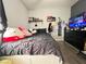 Comfortable bedroom with a bed, dark comforter, decorative pillows, and shelving at 6292 Yucca Valley Ct, Las Vegas, NV 89142