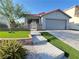Charming single-story home featuring a two-car garage, a well manicured lawn and decorative brickwork at 6292 Yucca Valley Ct, Las Vegas, NV 89142
