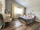 A cozy bedroom with hardwood floors, neutral walls, vaulted ceiling and ample natural light at 6292 Yucca Valley Ct, Las Vegas, NV 89142