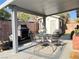 Back patio area featuring outdoor dining, fireplace and landscaping at 6292 Yucca Valley Ct, Las Vegas, NV 89142