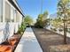 Clean side yard with gravel, concrete walkway, and young shade trees at 6292 Yucca Valley Ct, Las Vegas, NV 89142