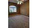 Comfortable carpeted bedroom with a large window and ceiling fan at 700 Carnegie St # 4113, Henderson, NV 89052